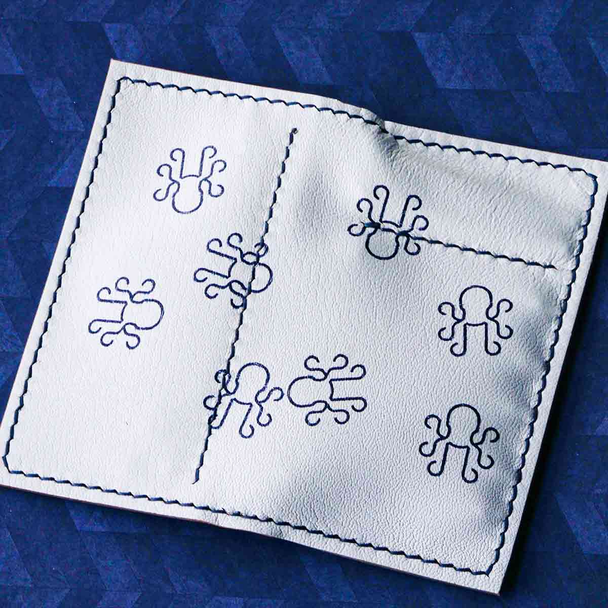 Seve Tool Holder Blacklist Edition in gray and white Alran Saffiano Chevre leather with scattered ink-stamped Kraken logos