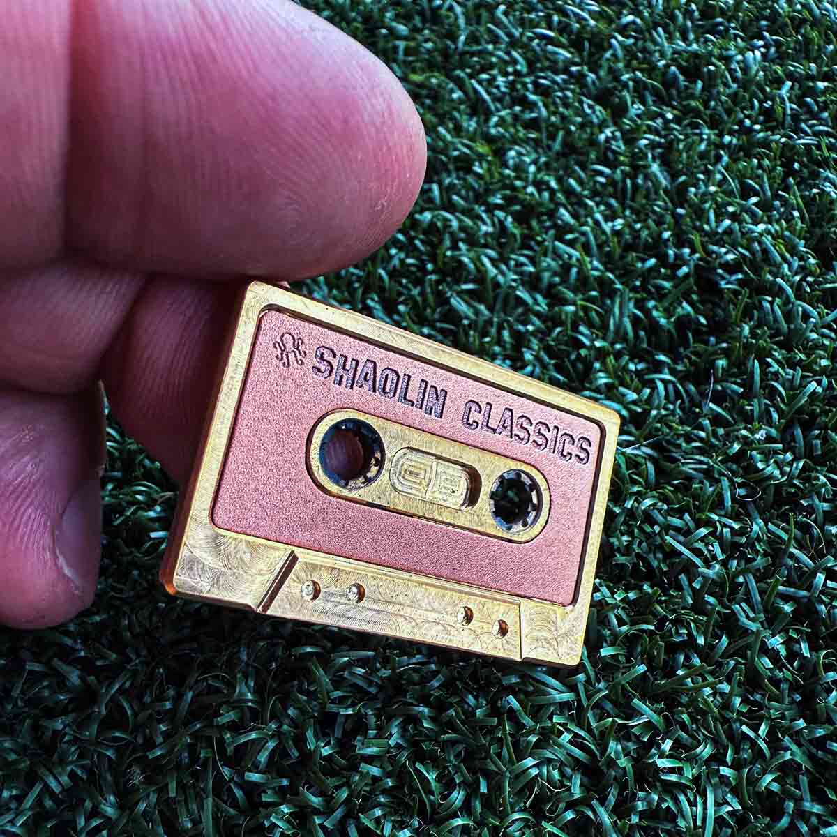 Brass and copper cassette golf ball marker with SHAOLIN CLASSICS inlay - front view