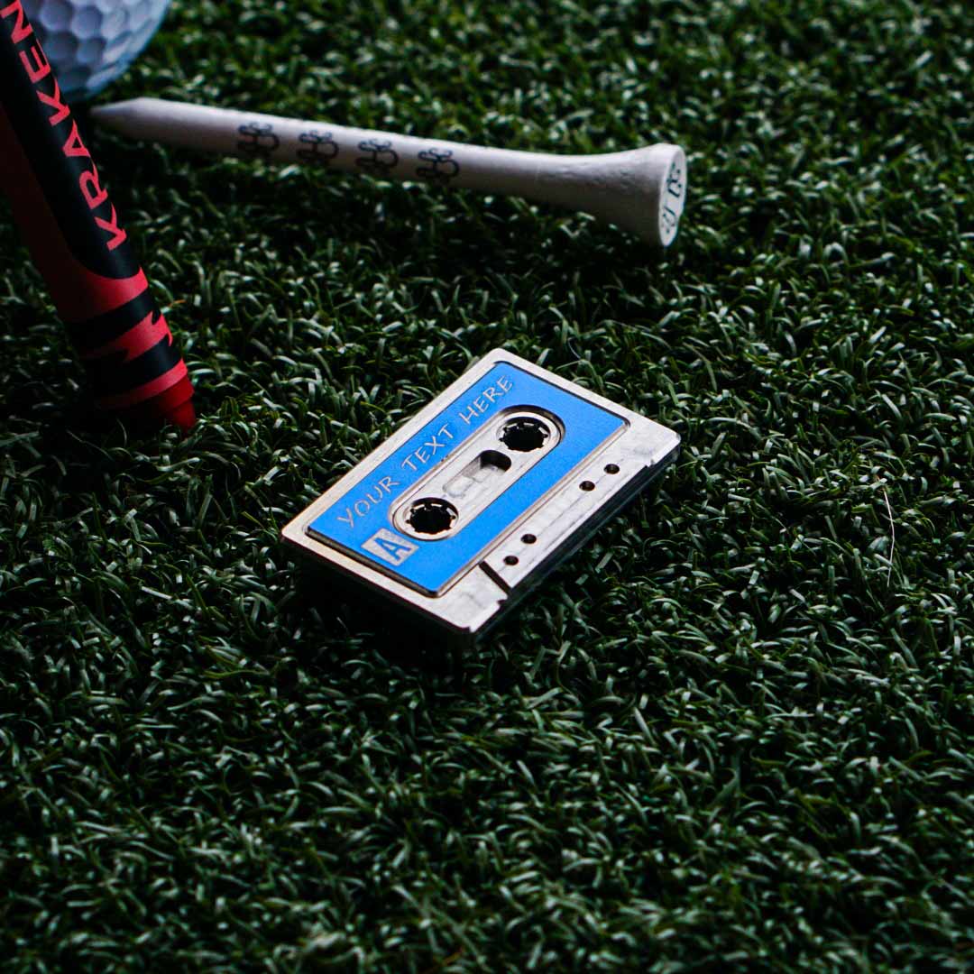 Side A: Legend custom cassette golf ball marker by Kraken Golf - stainless steel with blue aluminum inlay, personalized mixtape name