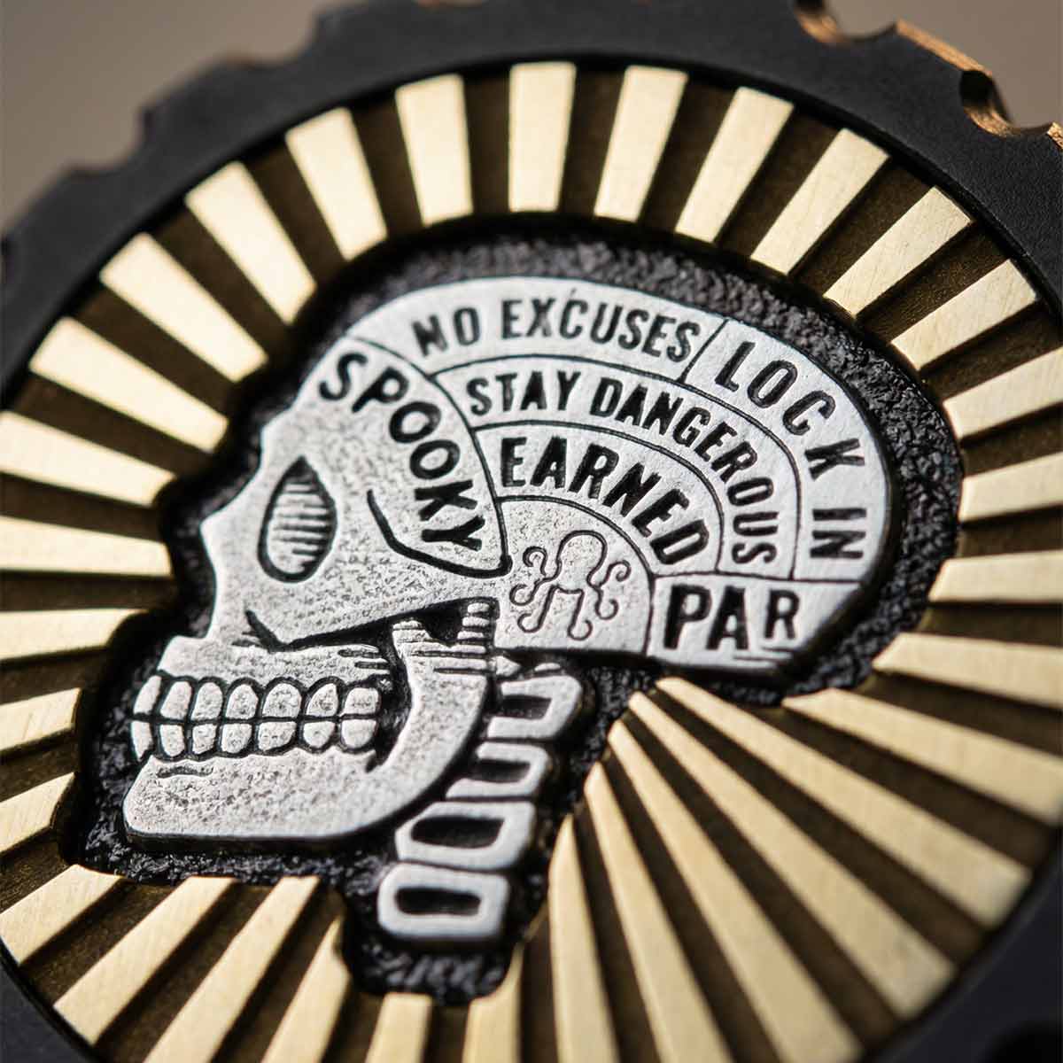 Signal Skull Marker macro - skull engraving detail and brass sunburst texture