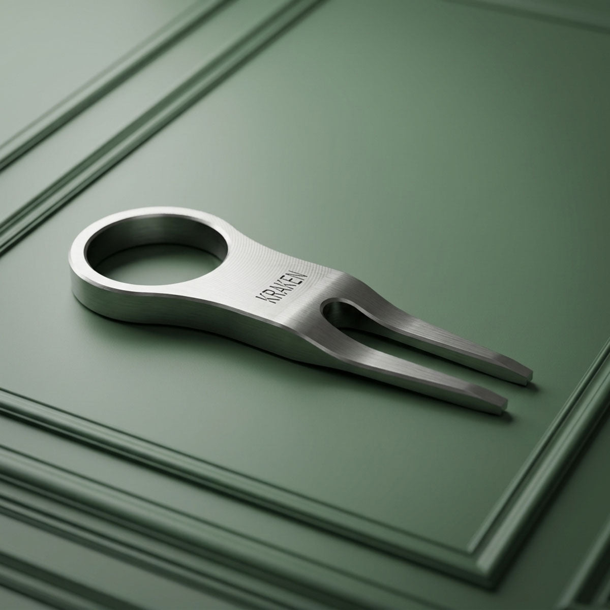 The Signet stainless steel golf pitch tool worn on finger like a ring