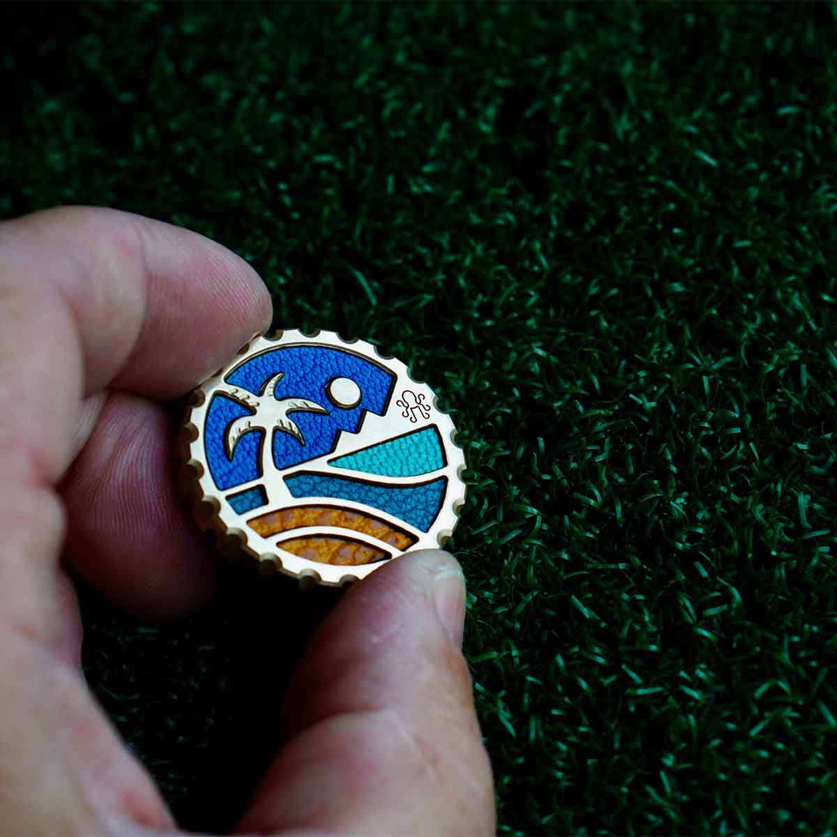 Close-up of EDC coin edge on Beachfront Escape solid brass golf marker - Kraken Golf limited edition craftsmanship