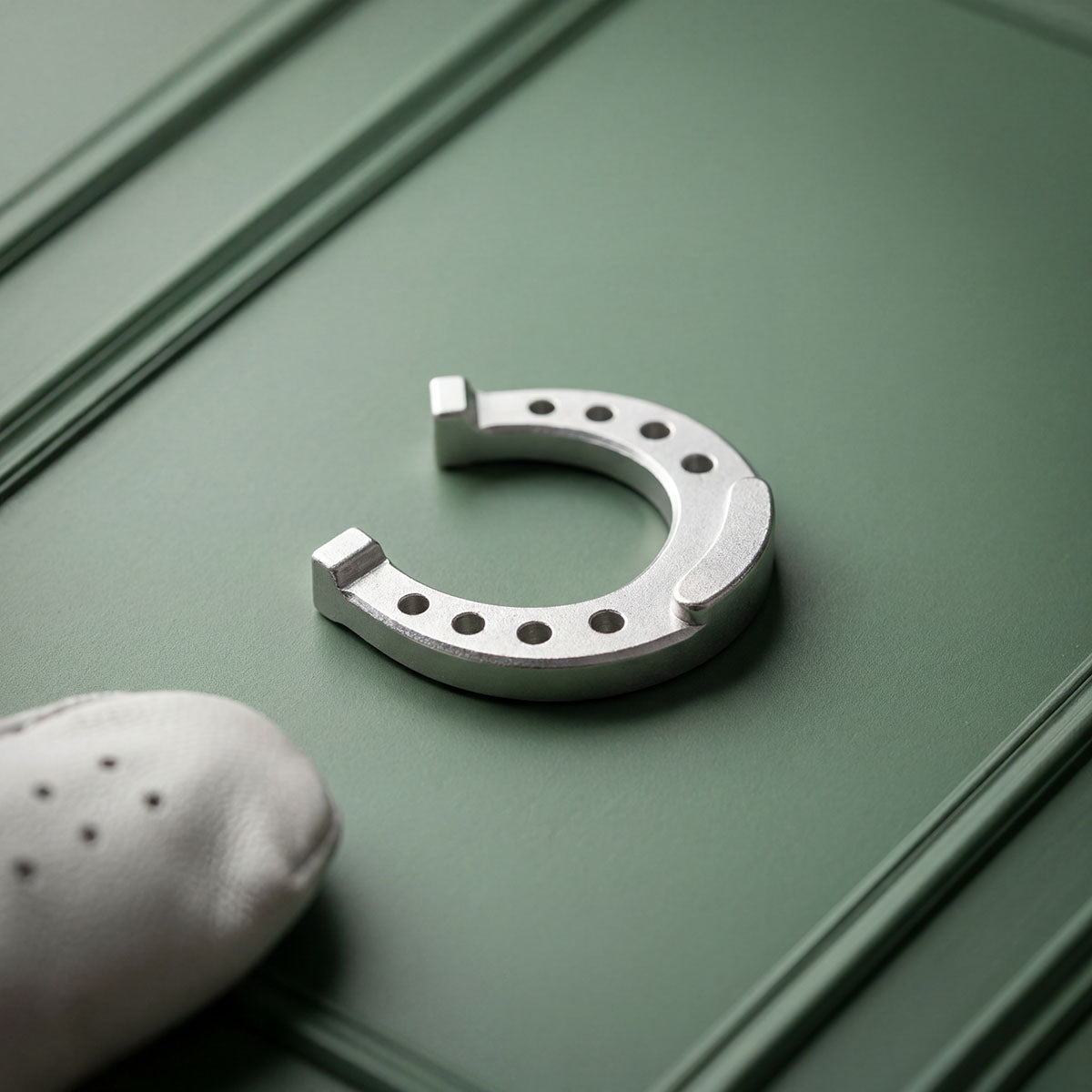 Stainless steel Lucky Horseshoe golf ball marker with engraved horseshoe design by Kraken Golf