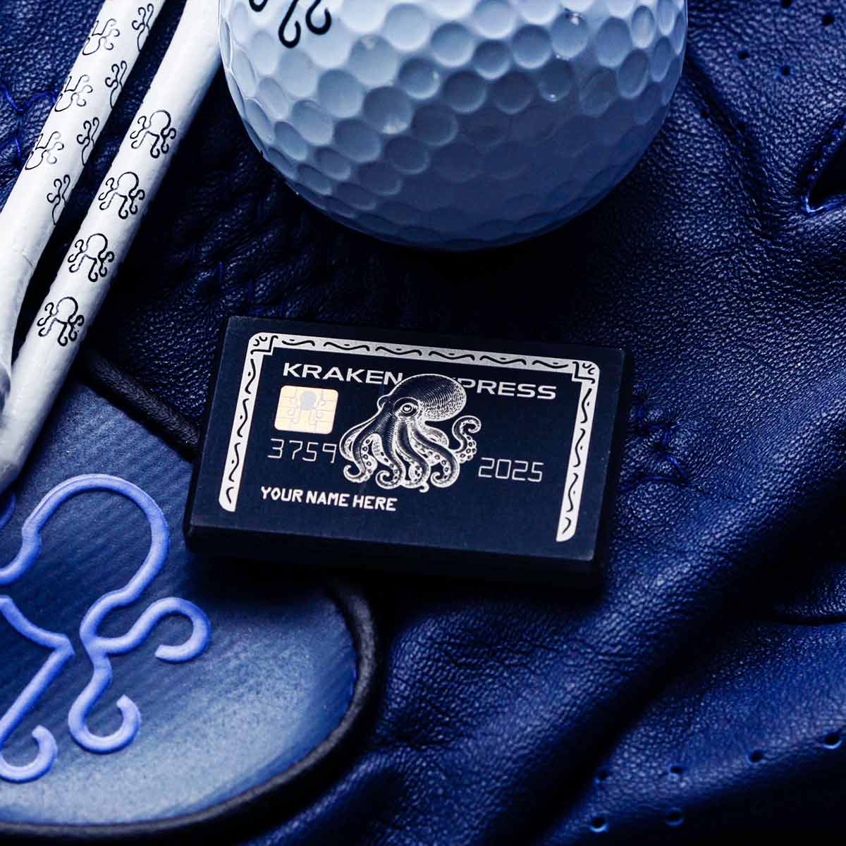 black credit card shaped ball marker on a golf glove
