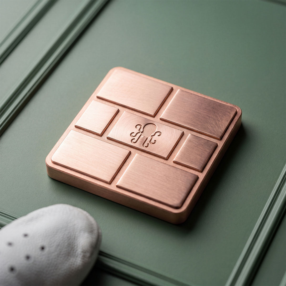The Coffer copper ball marker with coffered grid face, Kraken Golf