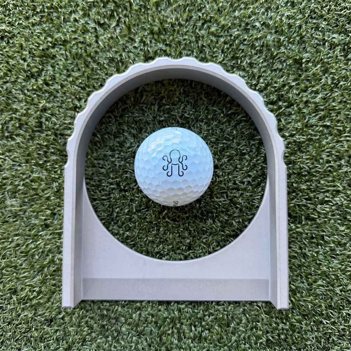 Overhead view of The Vision sculpted stainless steel putting portal with regulation golf hole width opening