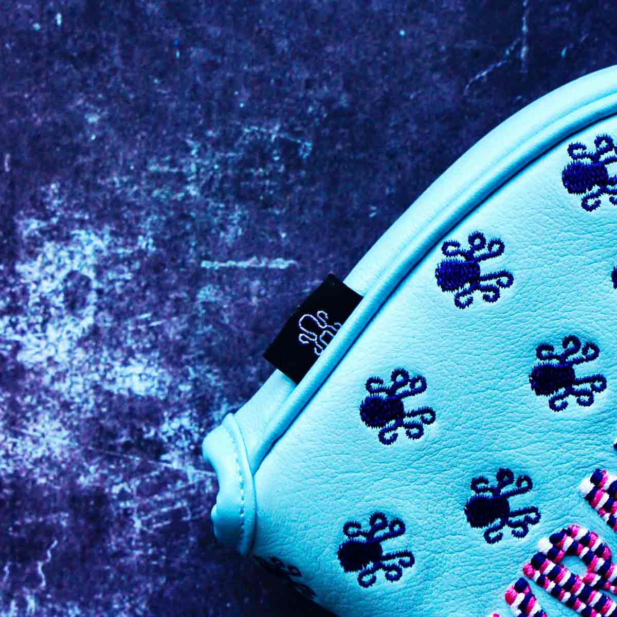Scattered navy Kraken logos and black Kraken tag on Vice Baby calfskin mallet cover