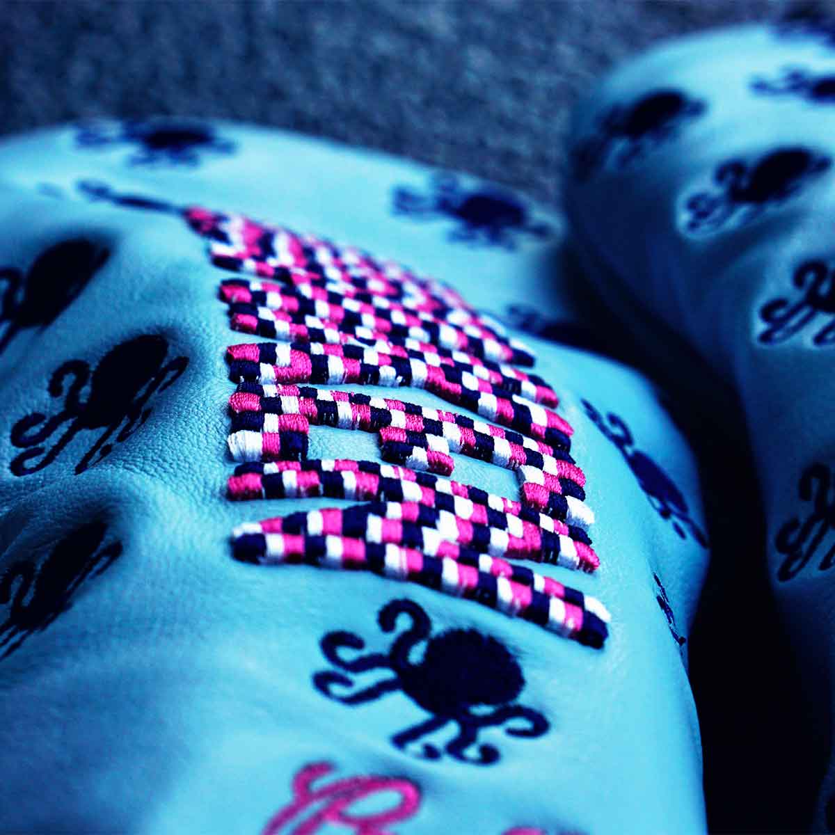 Raised KRAKEN embroidery in pixelated pink, navy, and white on Vice Baby headcover