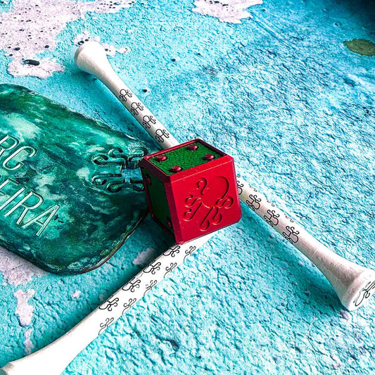 Watermelon golf ball marker cube with hot pink anodized finish and lime green leather inlays