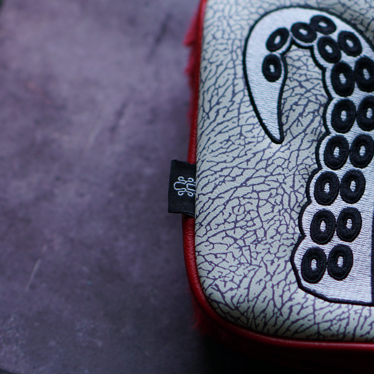 Blade-style golf headcover with plush red interior lining