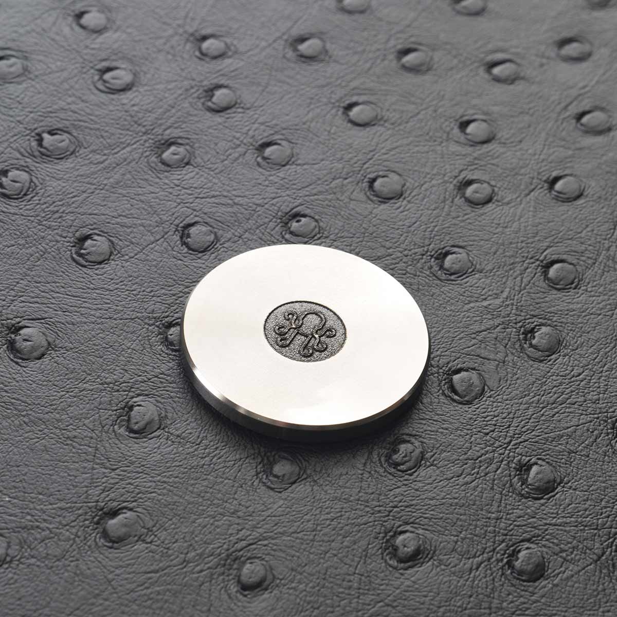Vinyl record-inspired golf marker in stainless steel finish