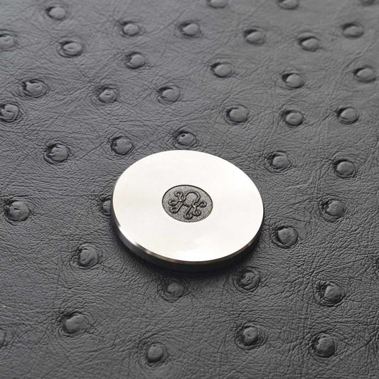Vinyl record-inspired golf marker in stainless steel finish